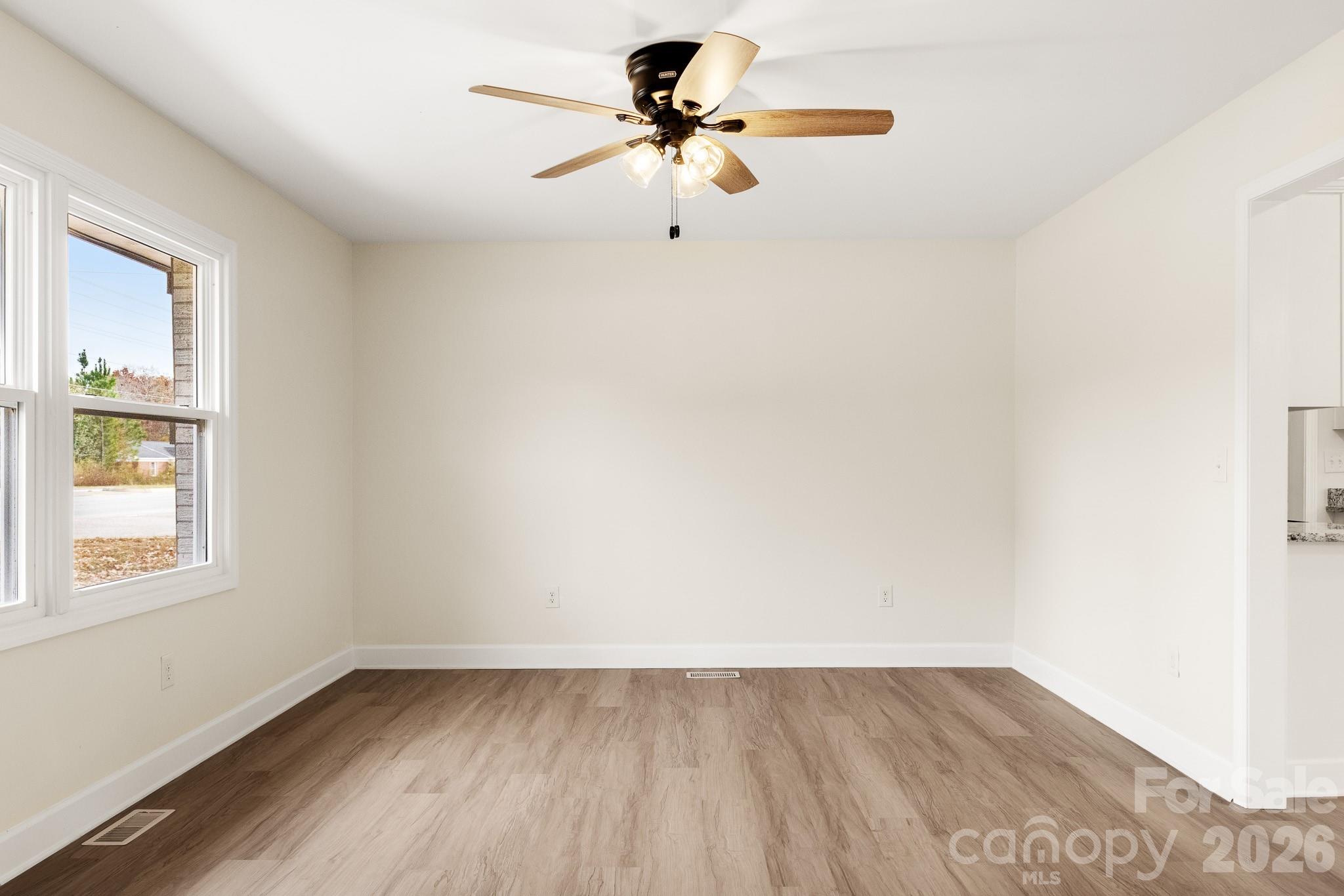 1152 Mt Holly Road Rock Hill, SC 29730 - Photo 4 of 41 a view of empty room with wooden floor and fan