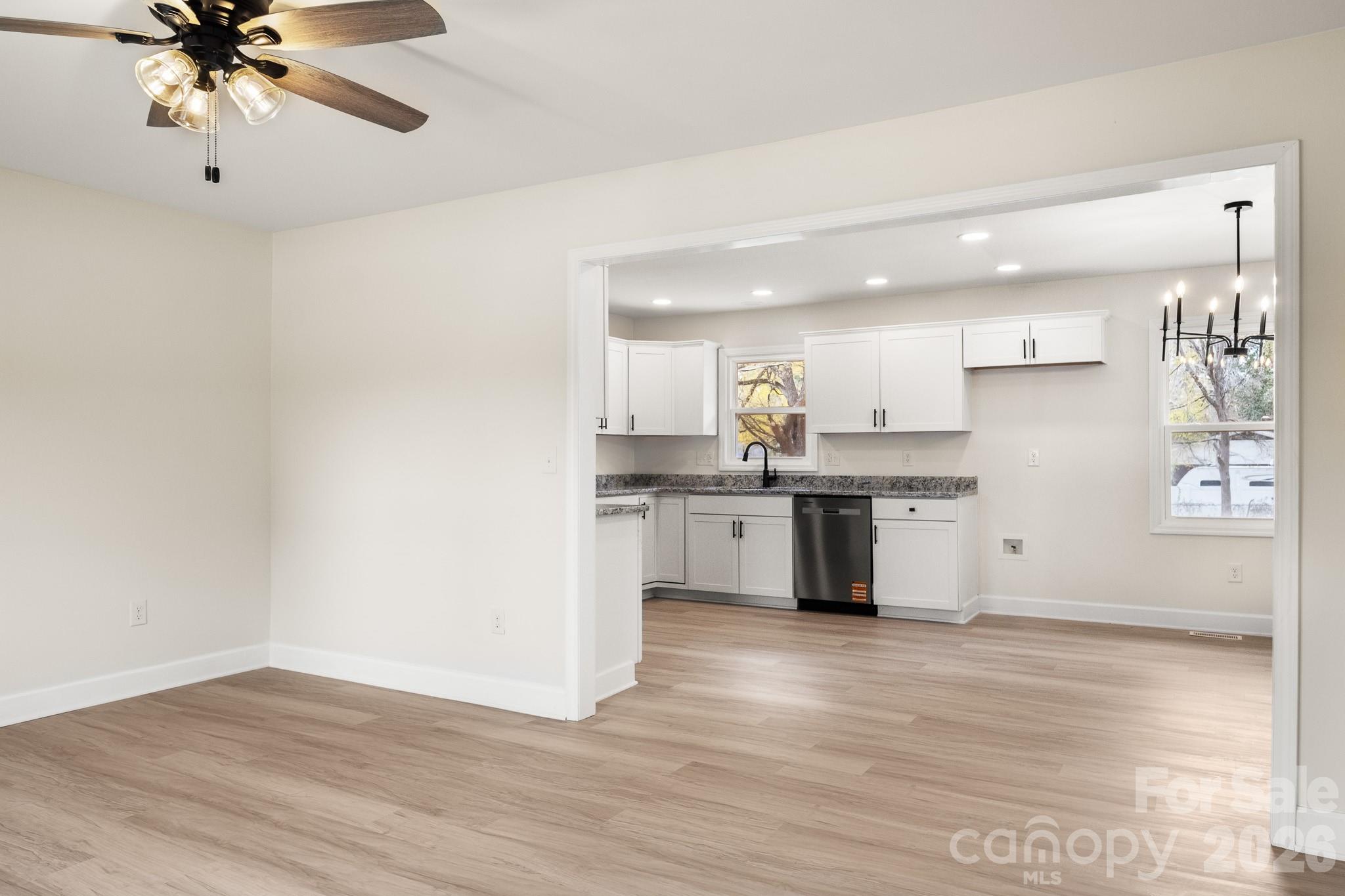 1152 Mt Holly Road Rock Hill, SC 29730 - Photo 5 of 41 a kitchen with a refrigerator and white cabinets
