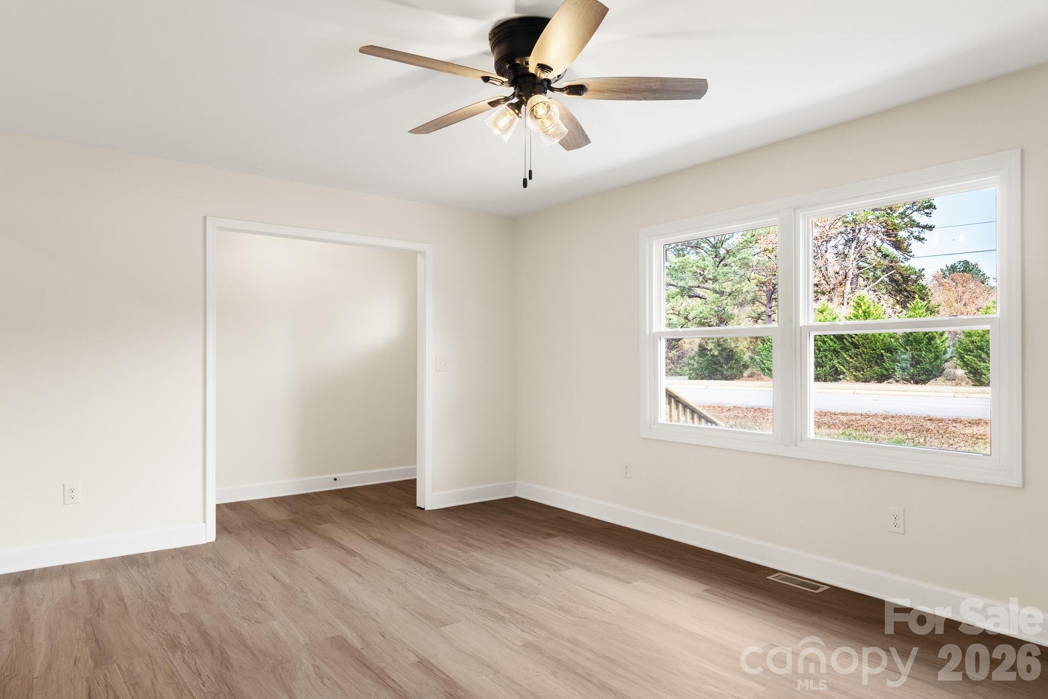 1152 Mt Holly Road Rock Hill, SC 29730 - Photo 6 of 41 an empty room with a window and a ceiling fan