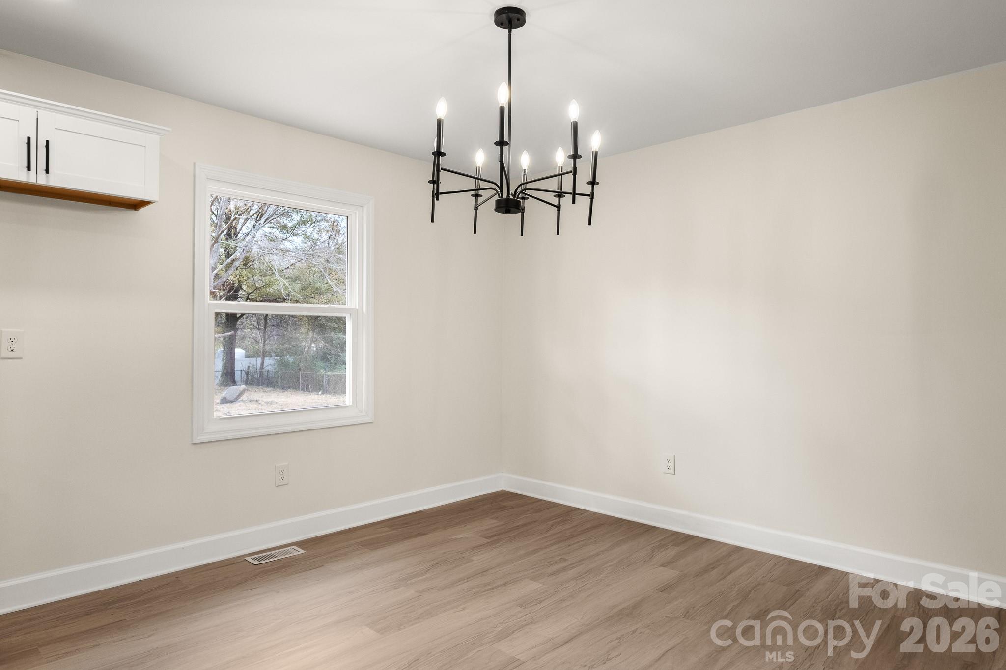 1152 Mt Holly Road Rock Hill, SC 29730 - Photo 9 of 41 an empty room with chandelier fan and windows