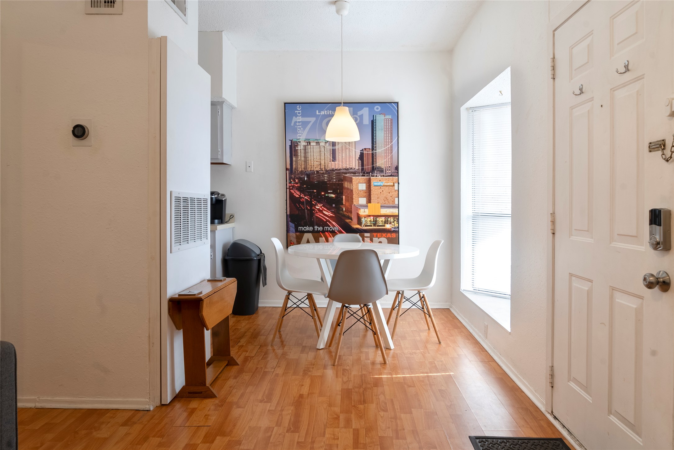 Dining area featuring light wood-style floors and baseboards