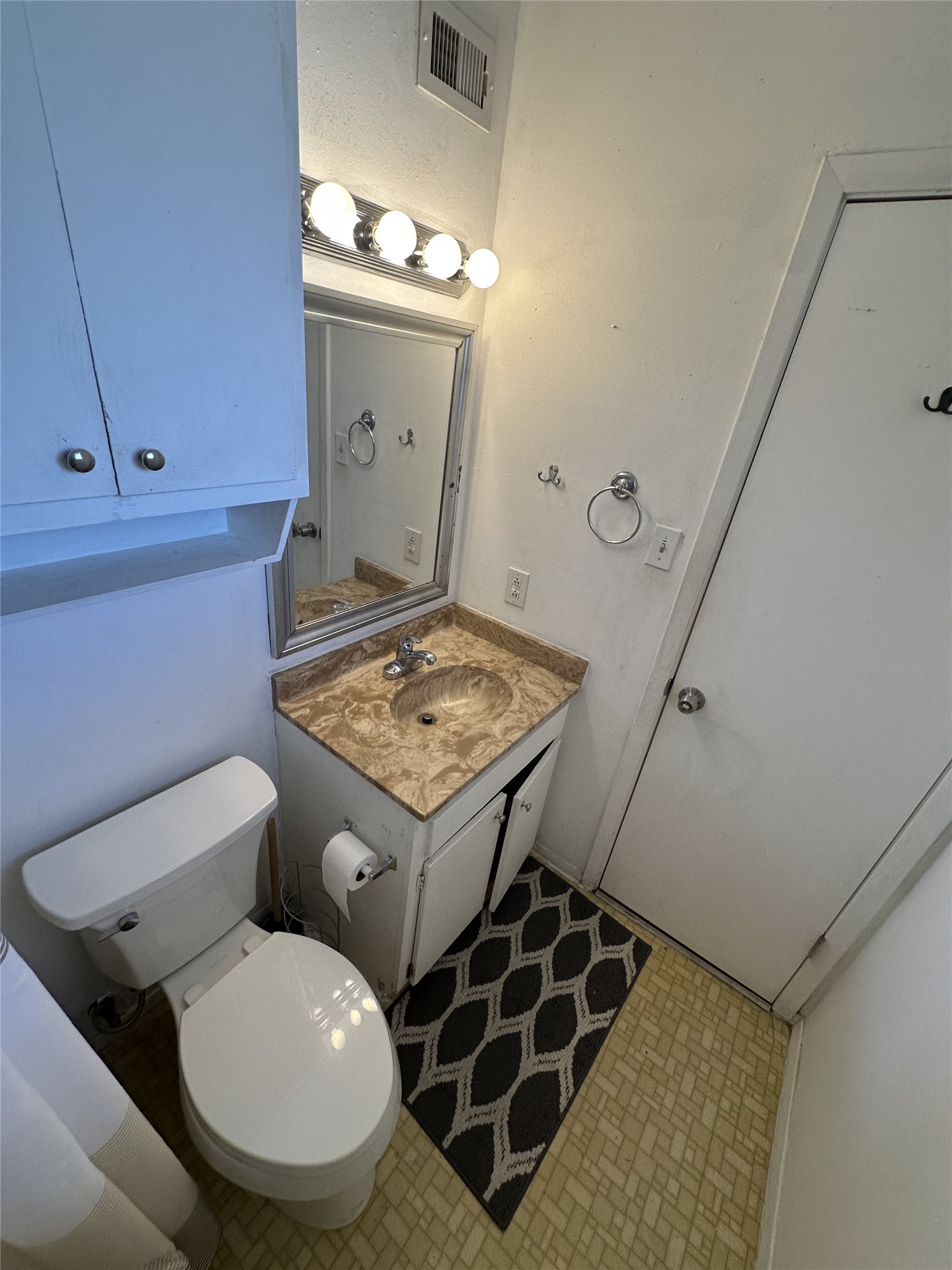 3316 Guadalupe Street, Unit 306 Austin, TX 78705 - Photo 16 of 28 Half bathroom with vanity and toilet