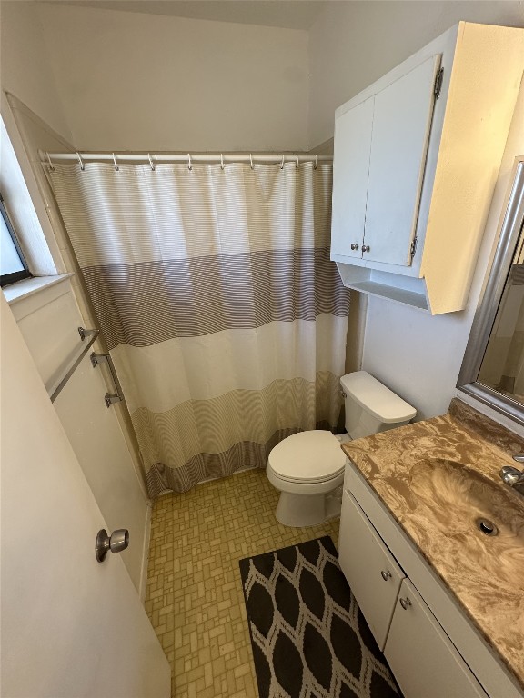 3316 Guadalupe Street, Unit 306 Austin, TX 78705 - Photo 17 of 28 a bathroom with a granite countertop sink and a toilet