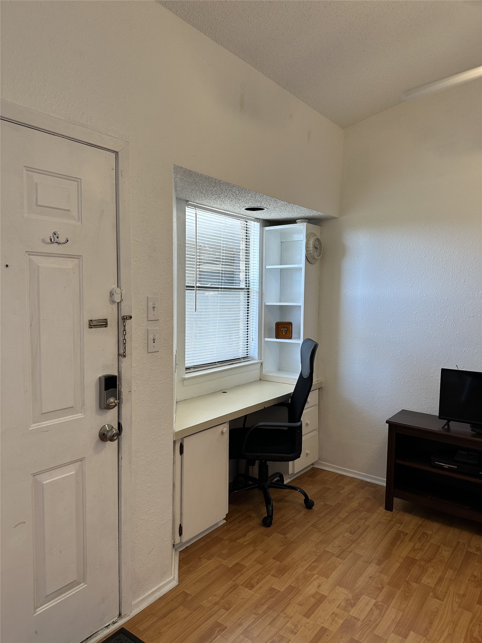 3316 Guadalupe Street, Unit 306 Austin, TX 78705 - Photo 18 of 28 Office area featuring light wood finished floors and a textured wall
