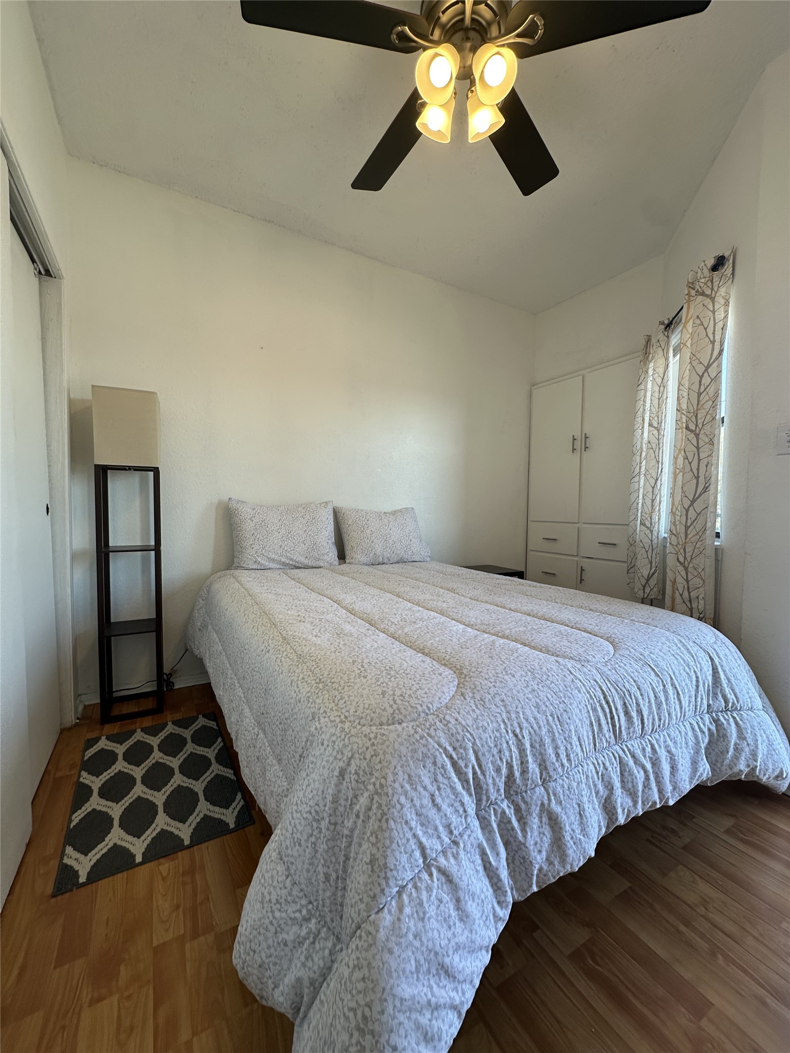 3316 Guadalupe Street, Unit 306 Austin, TX 78705 - Photo 19 of 28 Bedroom with a closet, wood finished floors, and a ceiling fan