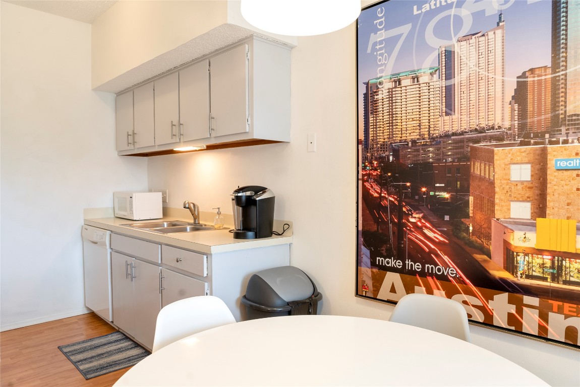 3316 Guadalupe Street, Unit 306 Austin, TX 78705 - Photo 2 of 28 a kitchen with stainless steel appliances a sink and cabinets