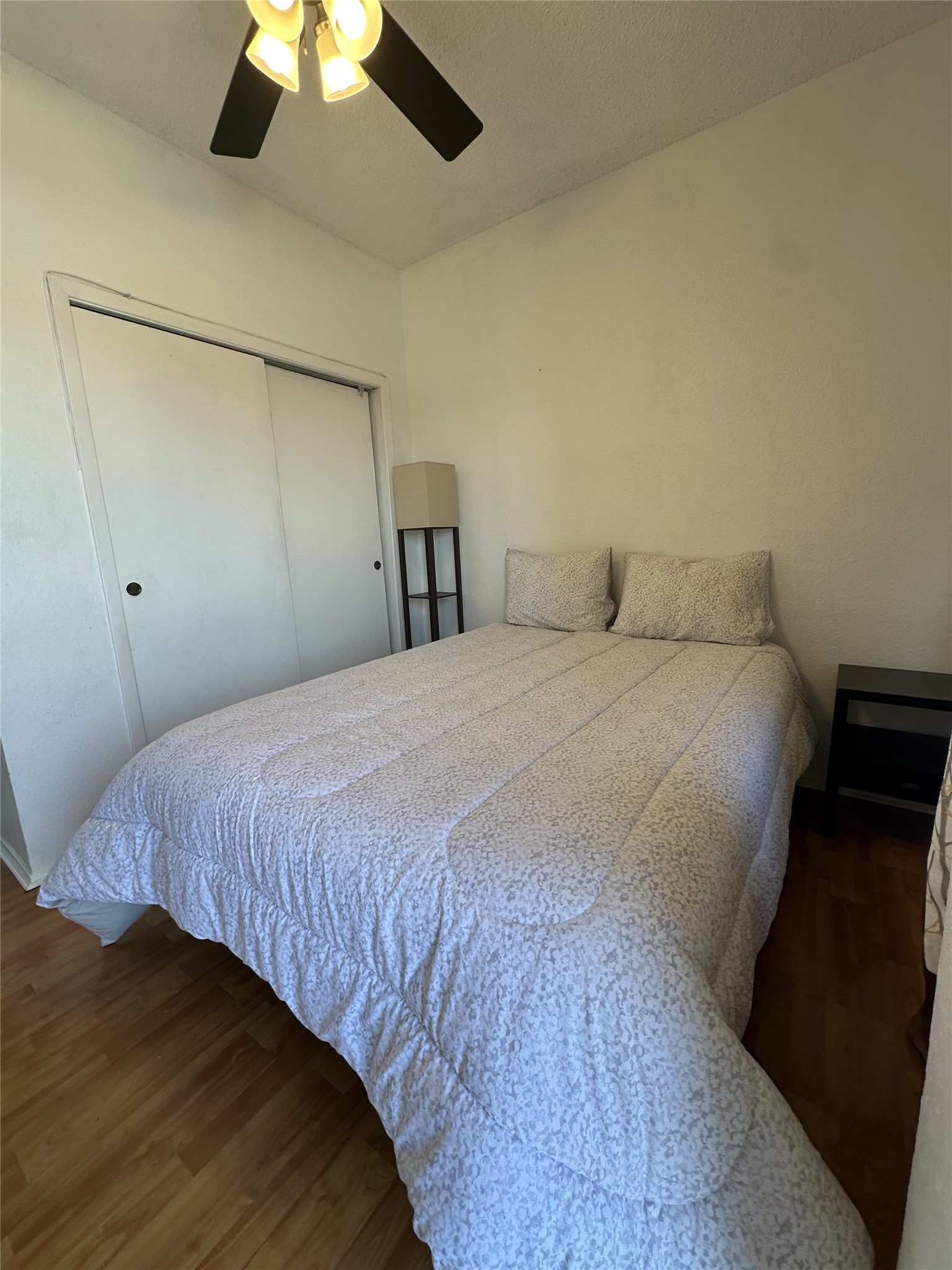 3316 Guadalupe Street, Unit 306 Austin, TX 78705 - Photo 21 of 28 Bedroom with dark wood-type flooring, a ceiling fan, and a closet