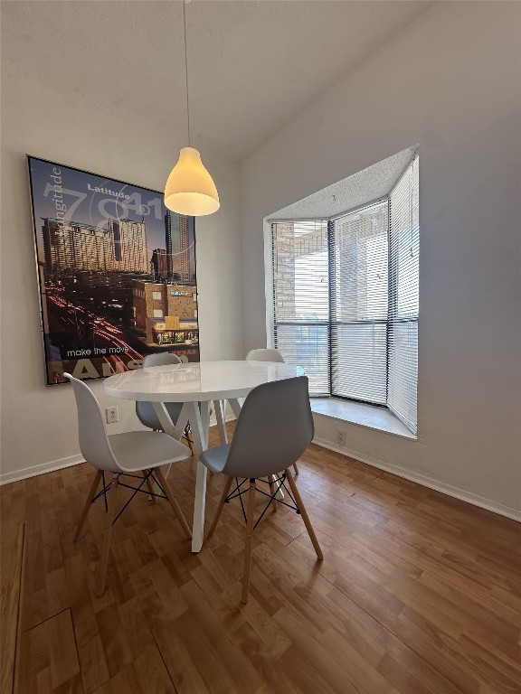 3316 Guadalupe Street, Unit 306 Austin, TX 78705 - Photo 22 of 28 a view of a dining room with furniture window and wooden floor