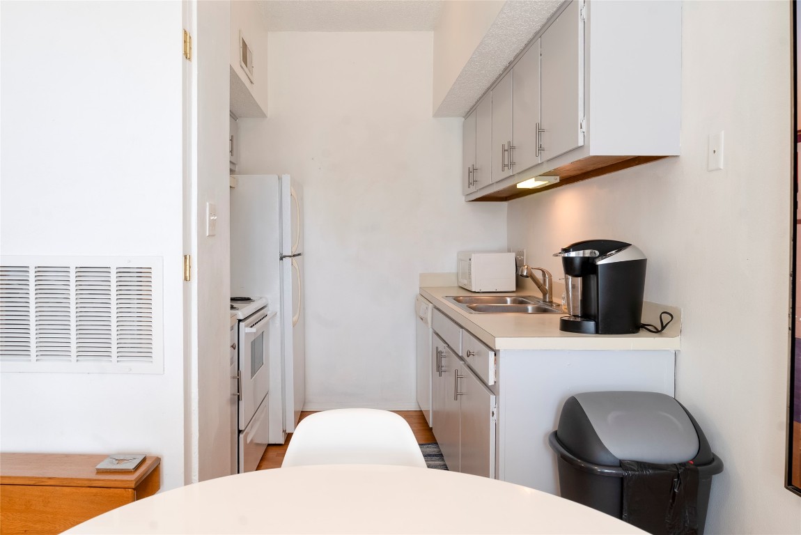 3316 Guadalupe Street, Unit 306 Austin, TX 78705 - Photo 5 of 28 a bathroom with a toilet a sink and a mirror