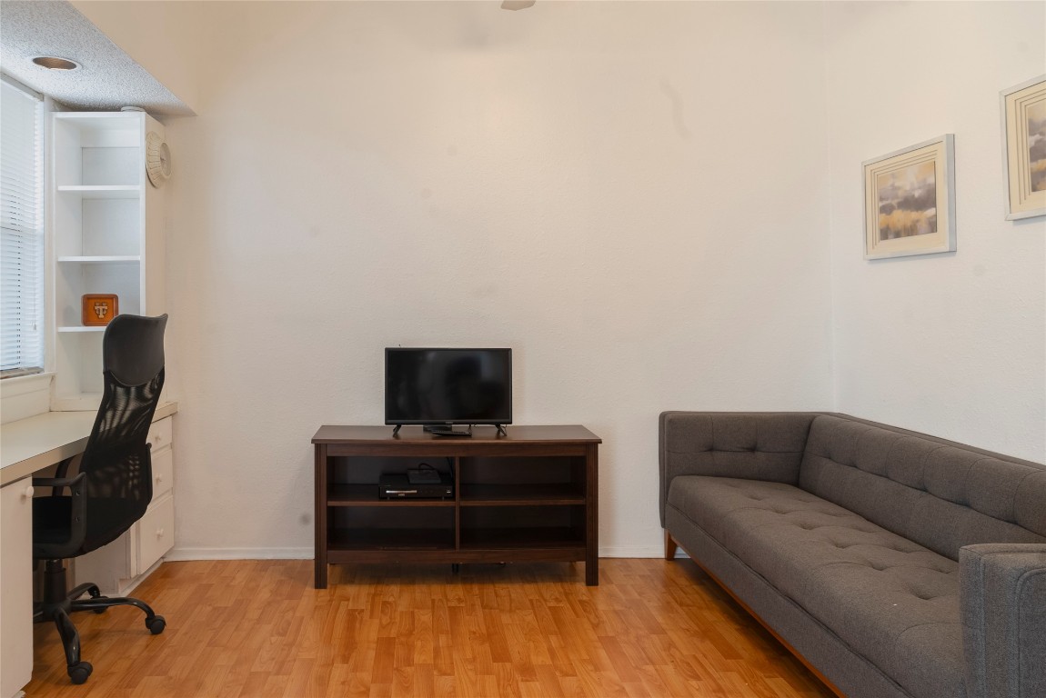 3316 Guadalupe Street, Unit 306 Austin, TX 78705 - Photo 6 of 28 a living room with furniture and a flat screen tv