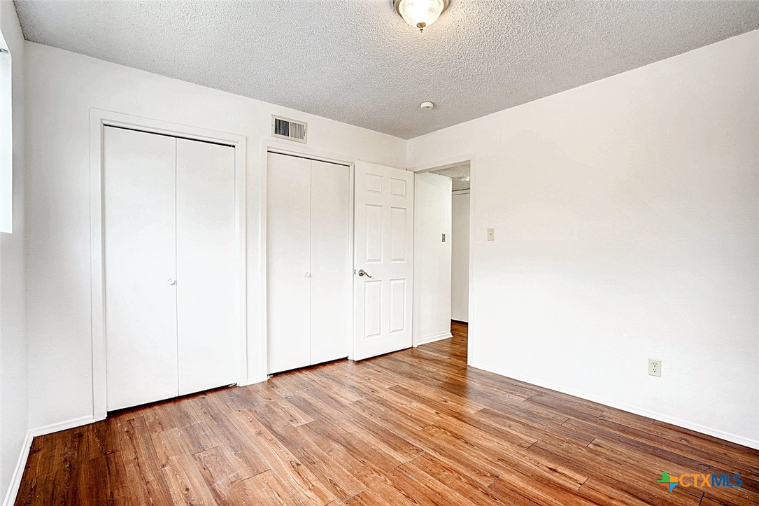 728 Old Martindale Road San Marcos, TX 78666 - Photo 15 of 16 a view of an empty room with wooden floor