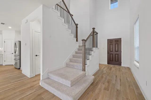 a view of entryway and hall with wooden floor
