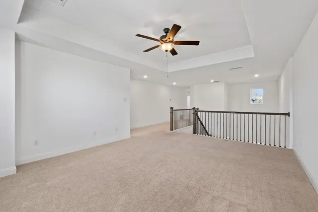 a view of a livingroom with a ceiling fan and window