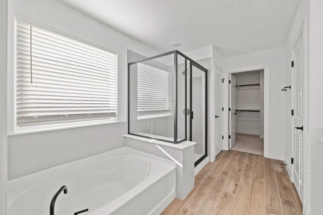 a bathroom with a tub and a shower