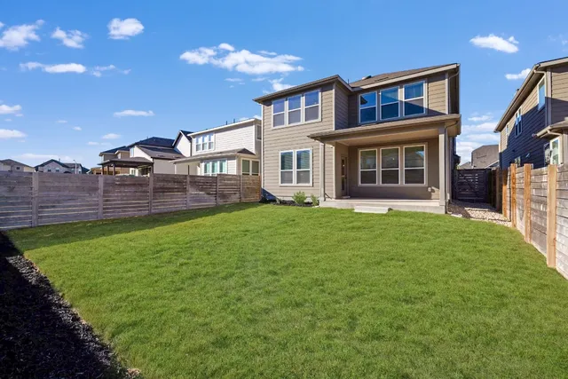 a front view of a house with a garden and yard