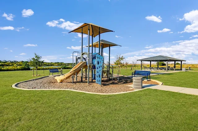 a view of a house with swimming pool and a yard