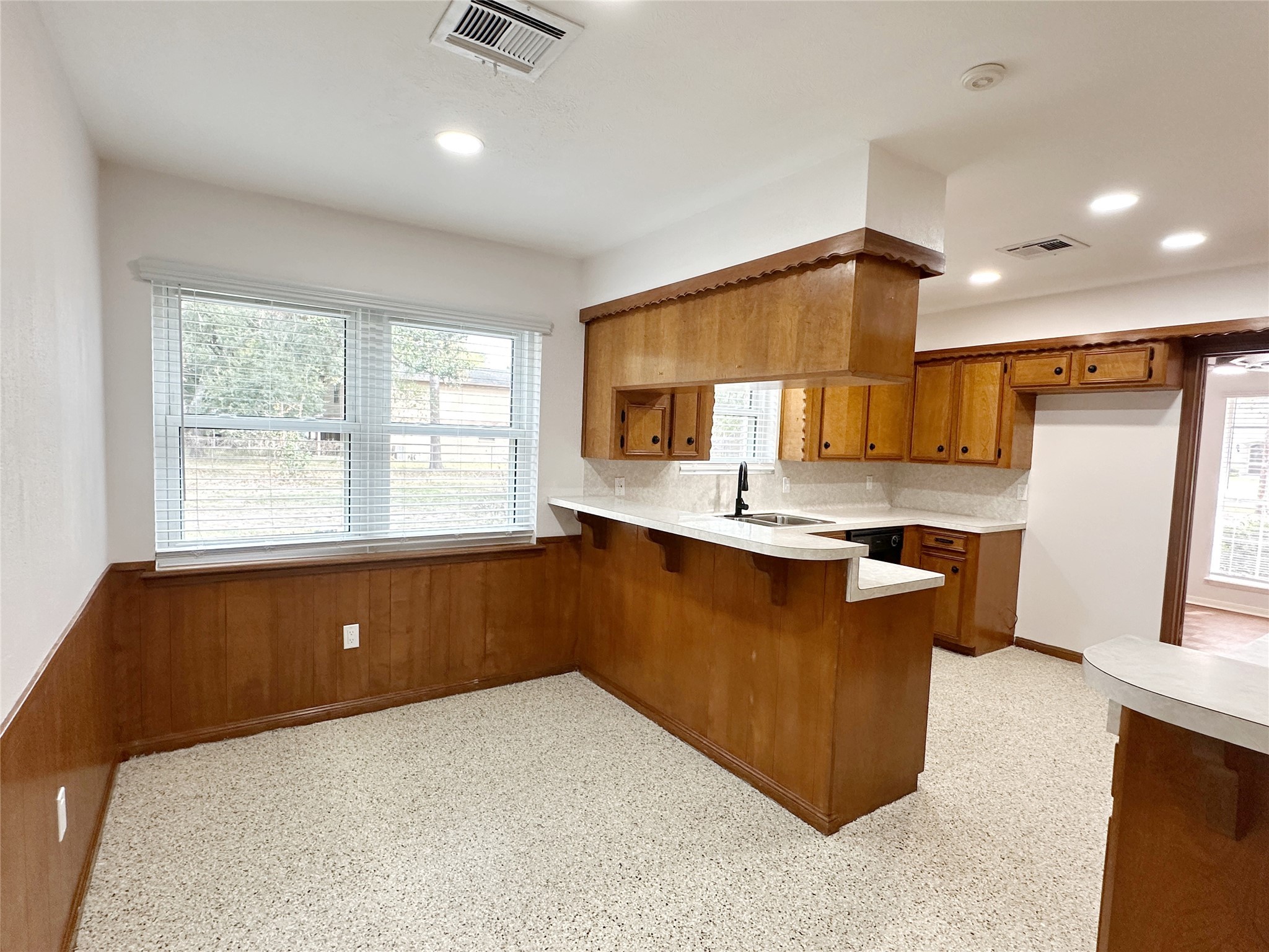 24342 East Webb Road Porter, TX 77365 - Photo 5 of 15 a kitchen with kitchen island granite countertop a sink refrigerator stove and microwave