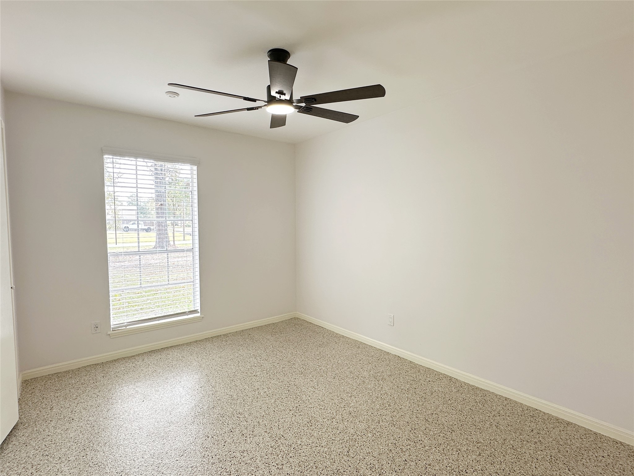24342 East Webb Road Porter, TX 77365 - Photo 8 of 15 an empty room with windows and fan