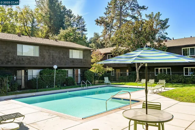 a view of a house with a garden and pathway