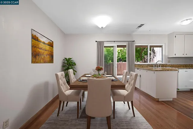 a view of a kitchen with wooden floor and a window