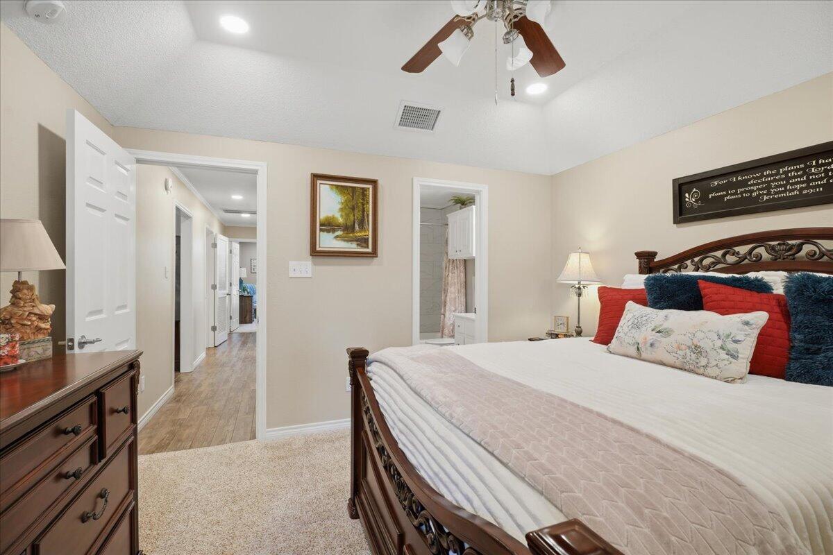 4612 100th Street Lubbock, TX 79424 - Photo 38 of 55 a bedroom with a bed and a flat screen tv
