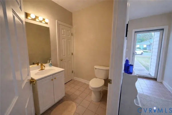 a view of a kitchen counter top space with sink wooden floor and windows