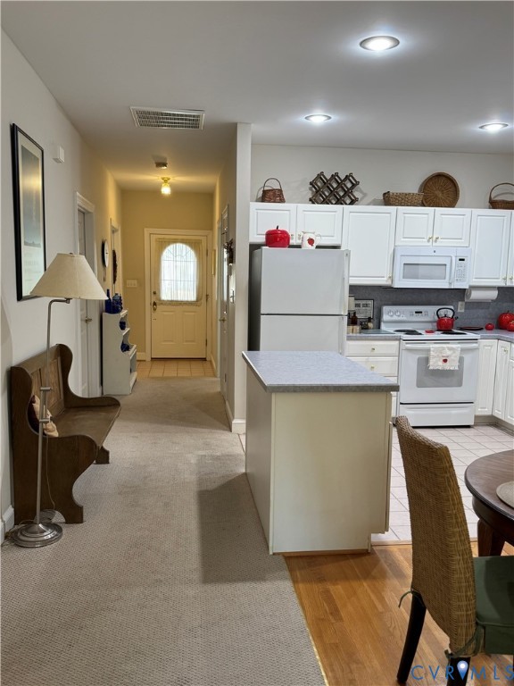 19 Bay Court Kilmarnock, VA 22482 - Photo 4 of 48 a kitchen with kitchen island a stove a table and chairs in it