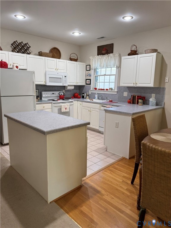 19 Bay Court Kilmarnock, VA 22482 - Photo 7 of 48 a kitchen with stainless steel appliances granite countertop a sink dishwasher a refrigerator and white cabinets with wooden floor