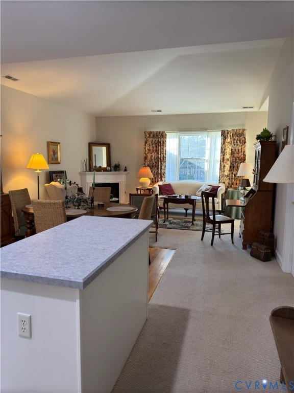19 Bay Court Kilmarnock, VA 22482 - Photo 8 of 48 a dining hall with couches a flat tv screen and a dining table with the kitchen view