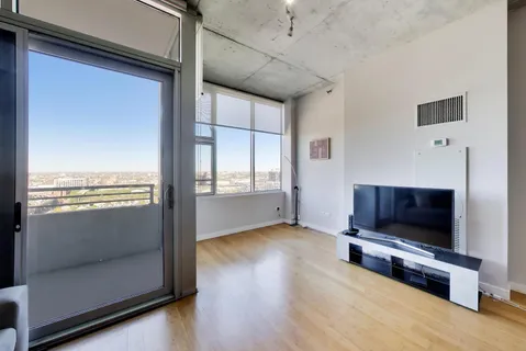 a living room with stainless steel appliances granite countertop furniture and a kitchen view