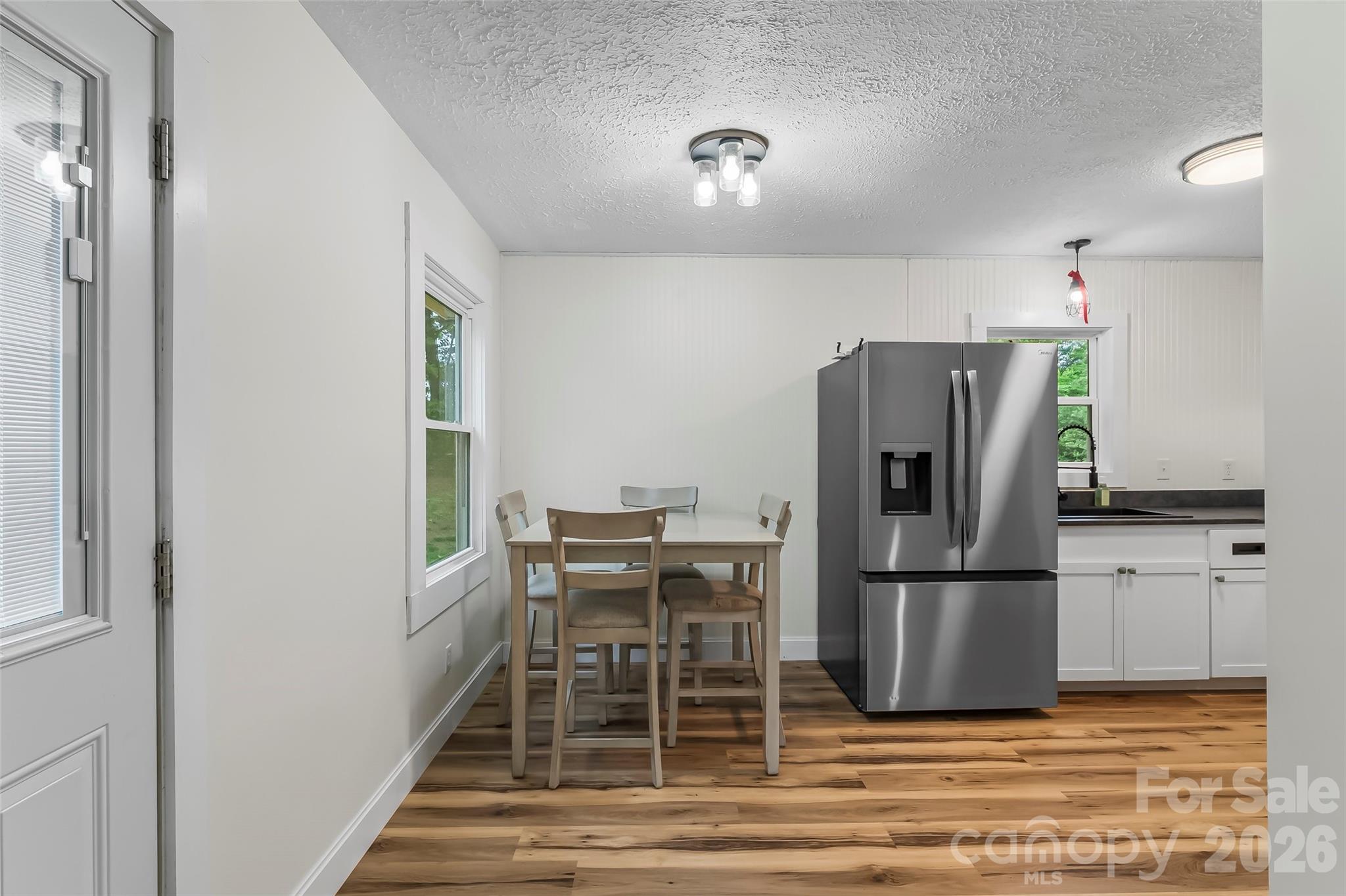 825 South Creek Road Nebo, NC 28761 - Photo 12 of 34 a kitchen with a refrigerator a table and chairs