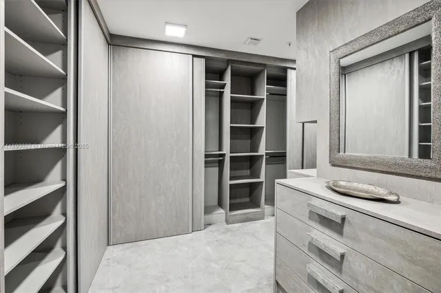 a bathroom with a tub sink shower and mirror