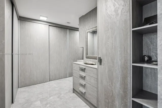 a white toilet sitting next to a shower