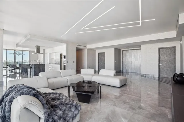 a large white kitchen with a large window and stainless steel appliances