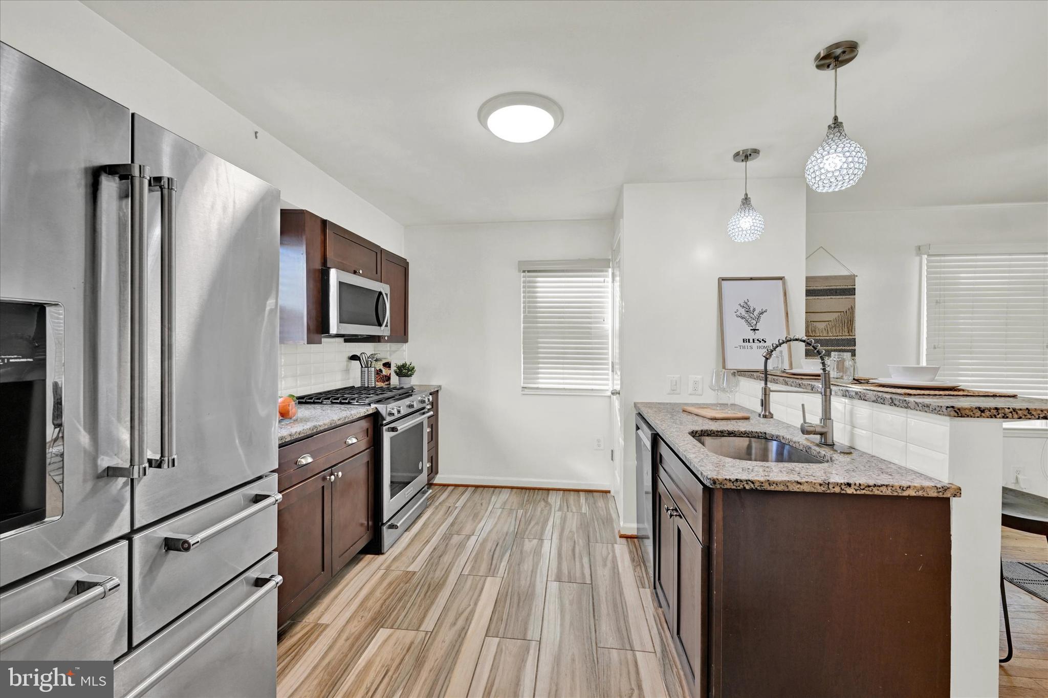 2019 Hillcrest Road Gwynn Oak, MD 21207 - Photo 11 of 29 a kitchen with granite countertop a sink appliances cabinets and counter space