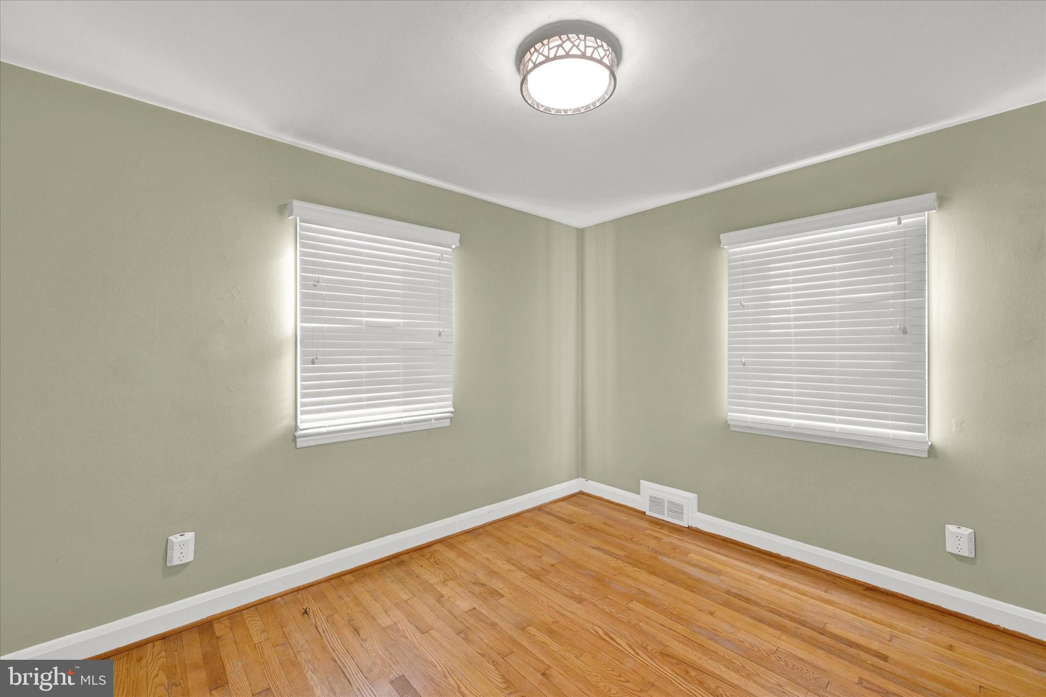 2019 Hillcrest Road Gwynn Oak, MD 21207 - Photo 17 of 29 a view of an empty room with wooden floor and a window