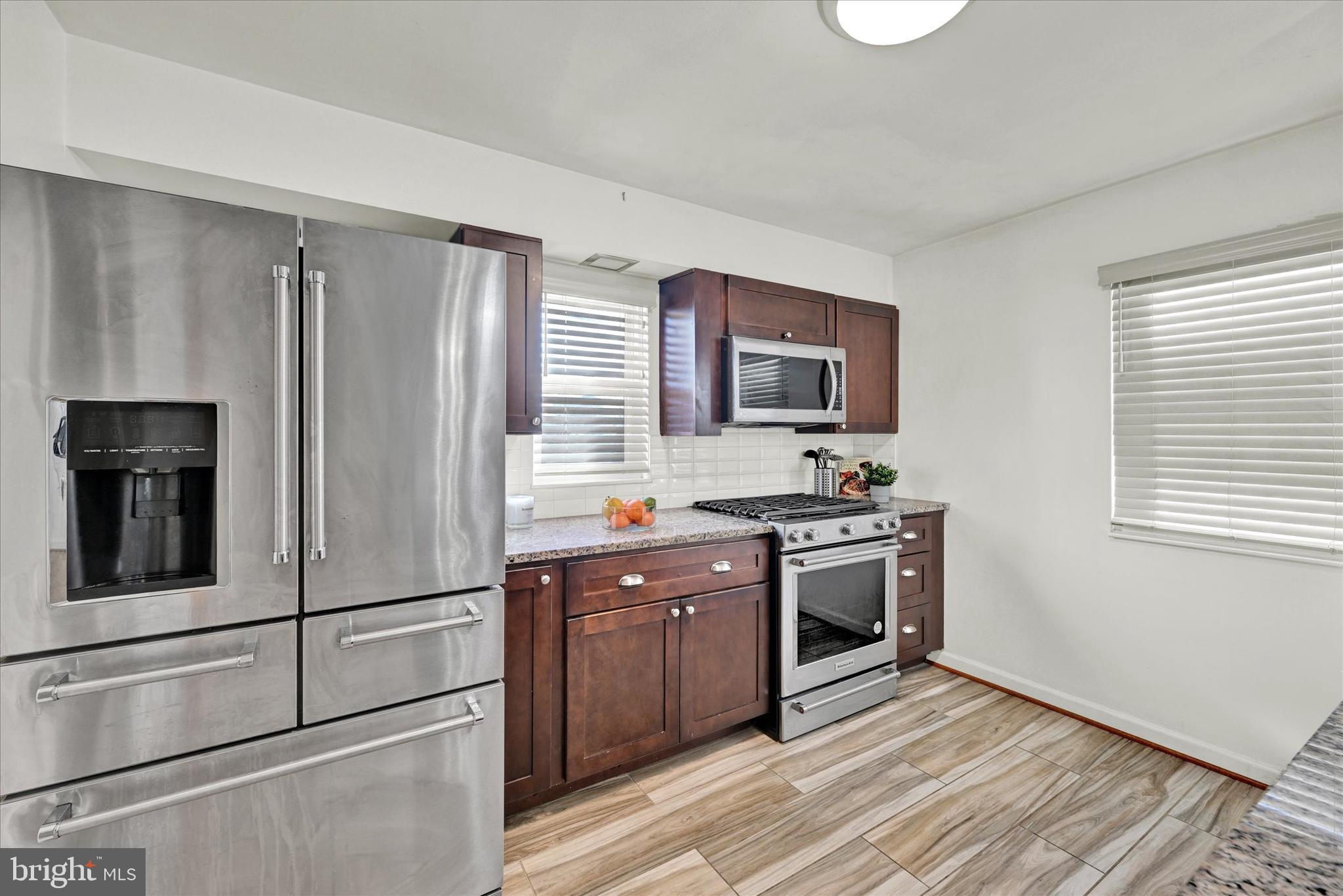 2019 Hillcrest Road Gwynn Oak, MD 21207 - Photo 8 of 29 a kitchen with stainless steel appliances granite countertop a refrigerator stove and sink