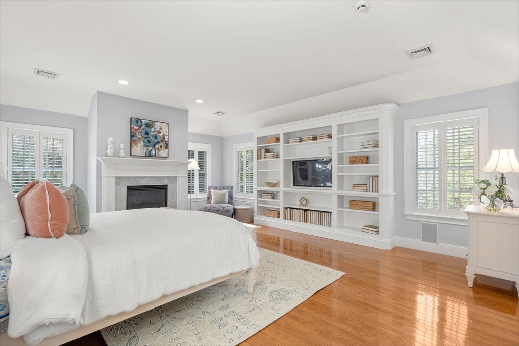 1 Beard Way Wellesley, MA 02482 - Photo 20 of 41 a spacious bedroom with a large bed and a fireplace