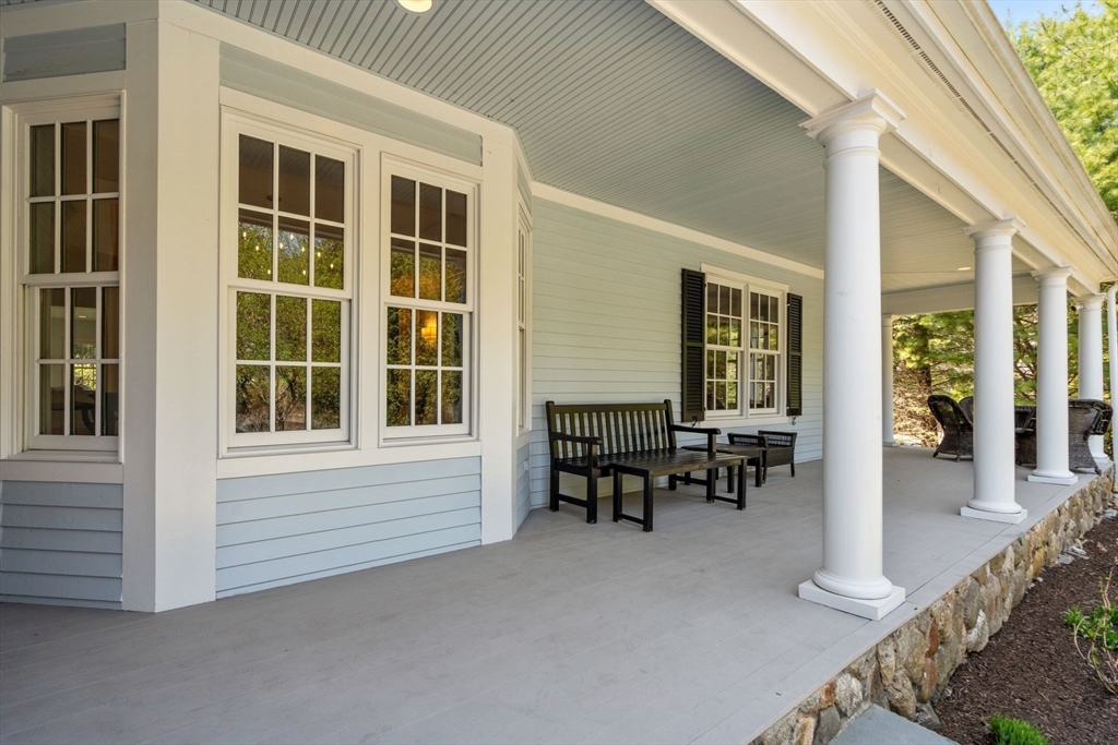 1 Beard Way Wellesley, MA 02482 - Photo 5 of 41 a view of a house with chairs and floor to ceiling window
