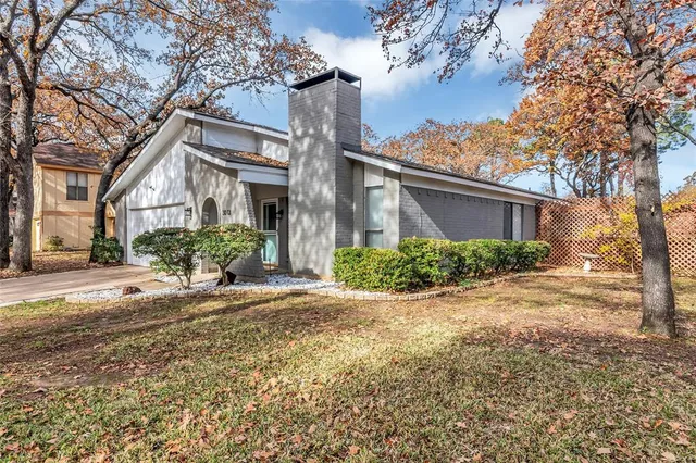 a front view of a house with a yard and a garage