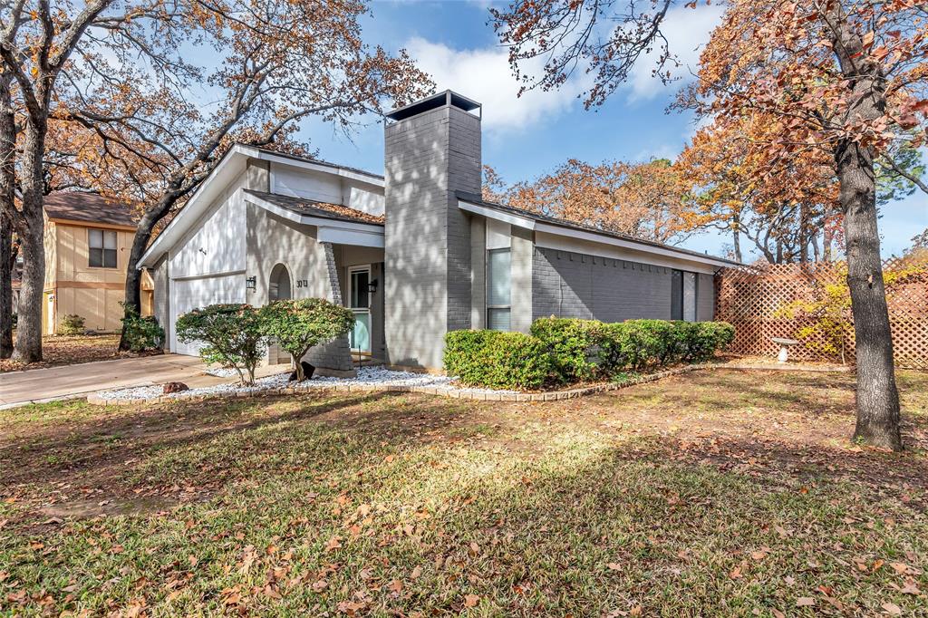 a front view of a house with a yard and a garage