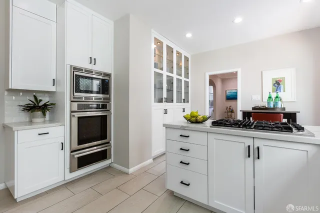 a kitchen with cabinets and appliances