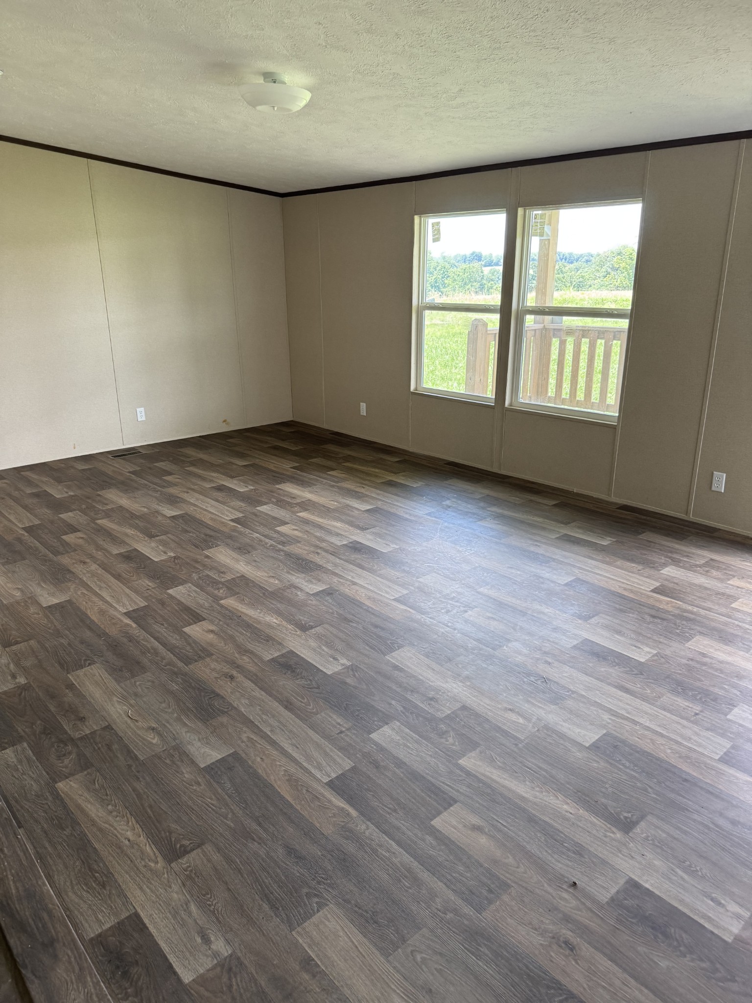 9392 Sunrise Road Red Boiling Springs, TN 37150 - Photo 3 of 12 an empty room with wooden floor and windows