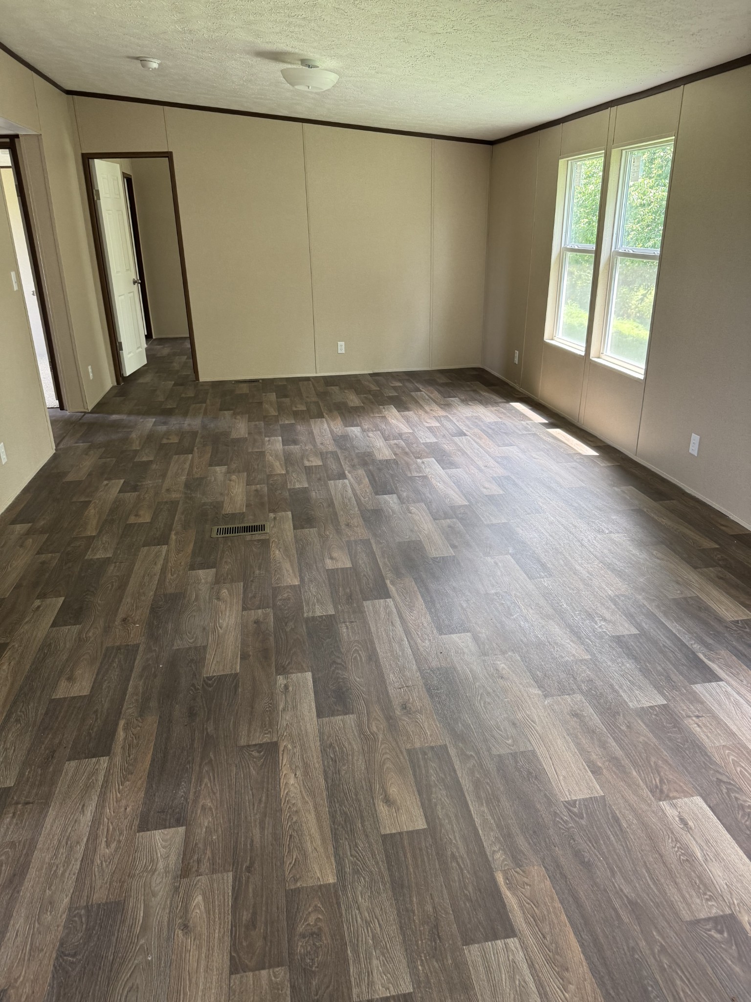 9392 Sunrise Road Red Boiling Springs, TN 37150 - Photo 6 of 12 a view of an empty room with wooden floor and a window