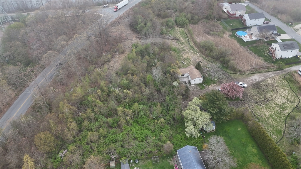 a aerial view of a house with a yard basket ball court