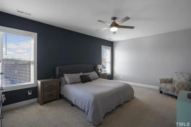 a bedroom with a bed and a ceiling fan