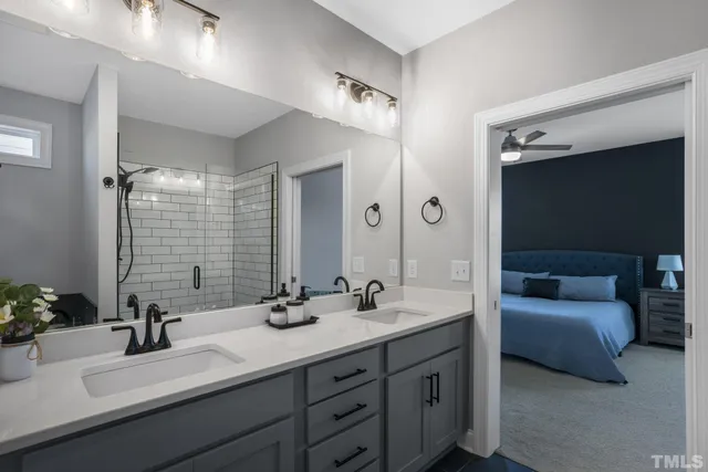 a bathroom with double vanity sinks double vanity tub and a mirror