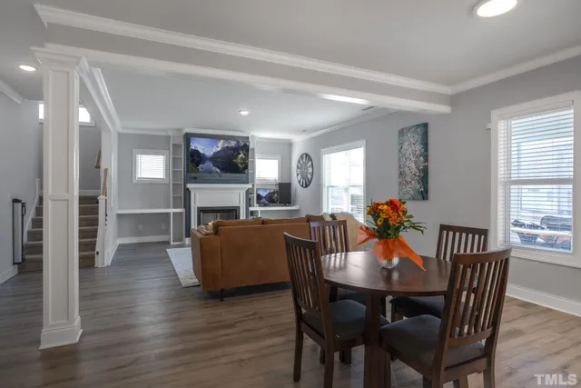 a view of a dining room with furniture window and wooden floor