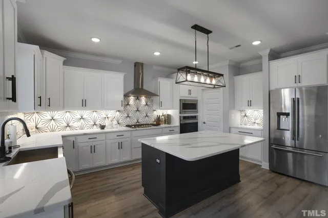 a kitchen with granite countertop cabinets a sink and stainless steel appliances