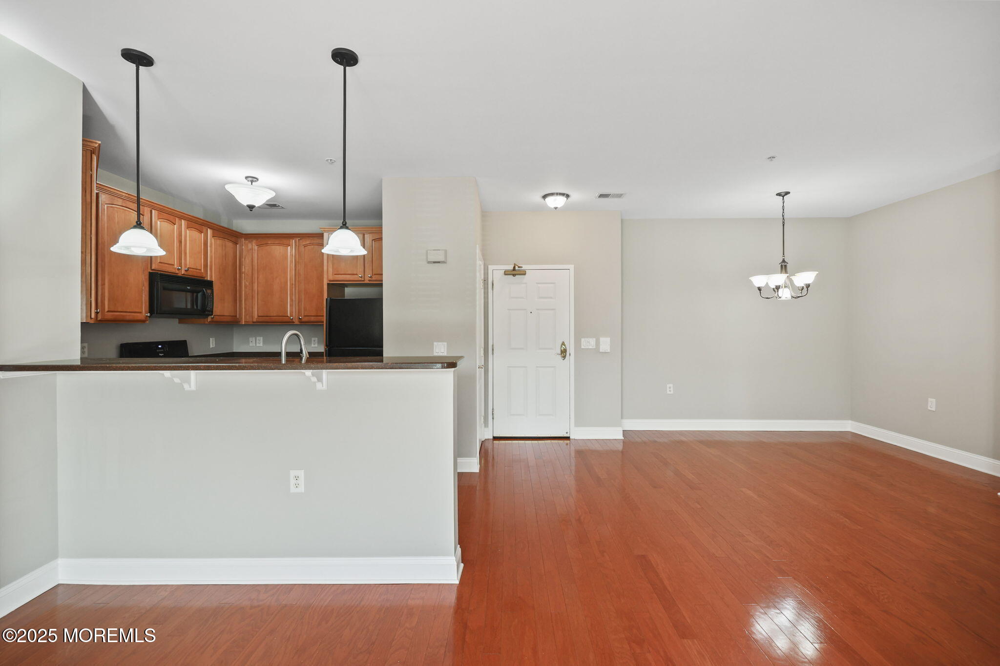 3208 Falston Circle, Unit 3208 Old Bridge, NJ 08857 - Photo 13 of 39 a view of a kitchen with a refrigerator a ceiling fan and a fireplace
